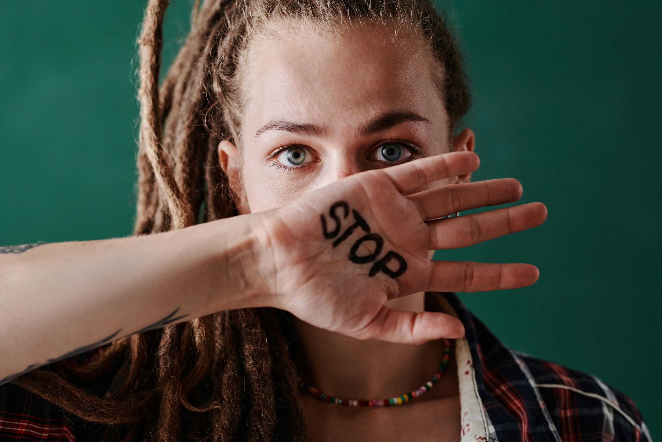 Decorative image of a person with STOP written on their hand
